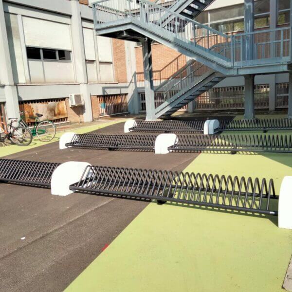 Fietsenrek met betonvoet direct online kopen Meerdere vrijstaande fietsenrekken met betonvoeten geplaatst op een binnenterrein van een instelling