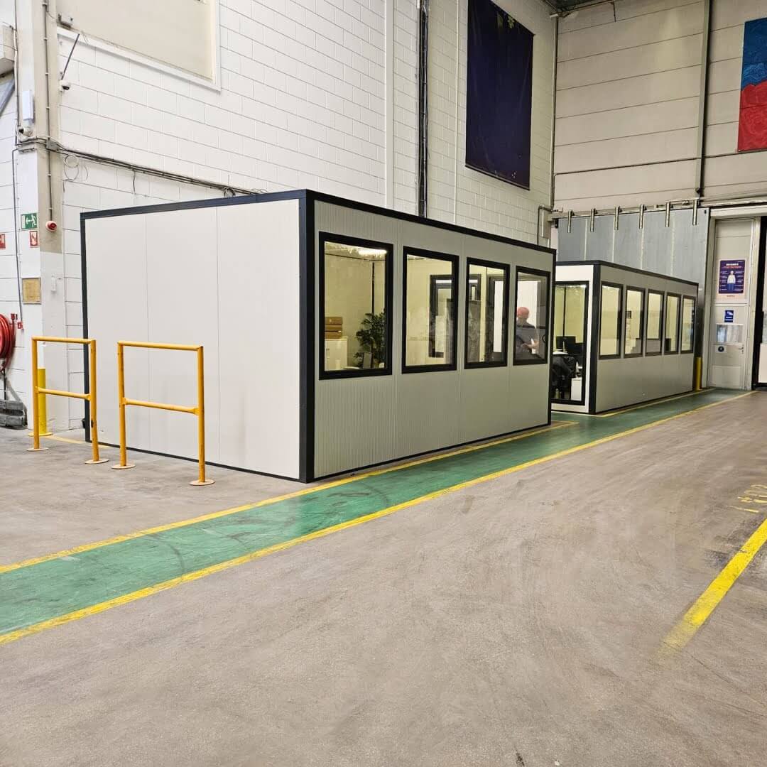 Modulaire kantoorunit van 4x3 meter met ramen, geplaatst in een industriële hal voor extra werkruimte.