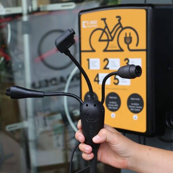 Laadstation Wandmontage – Oplaadpunt voor Elektrische Fietsen Laadstation voor elektrische fietsen met meerdere oplaadkabels en wandmontage-optie.